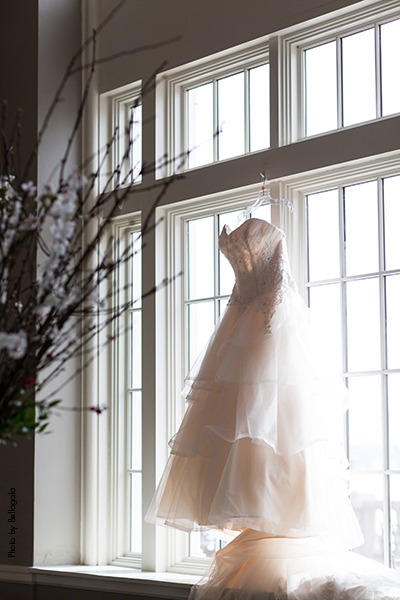 Wedding gown hangs before ceremony
