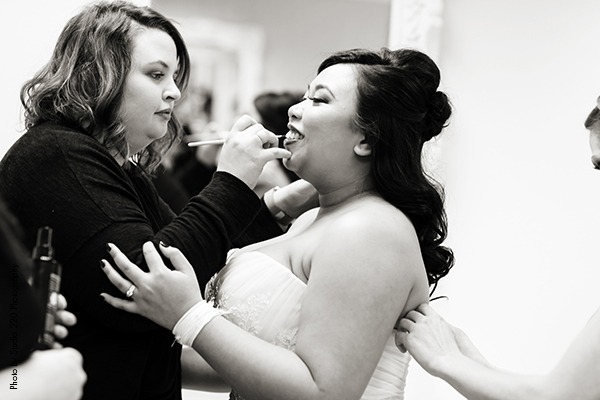 Bride getting makeup done before ceremony