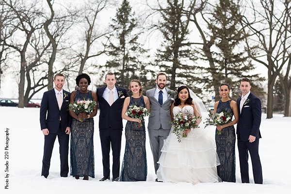 Wedding party standing in snow