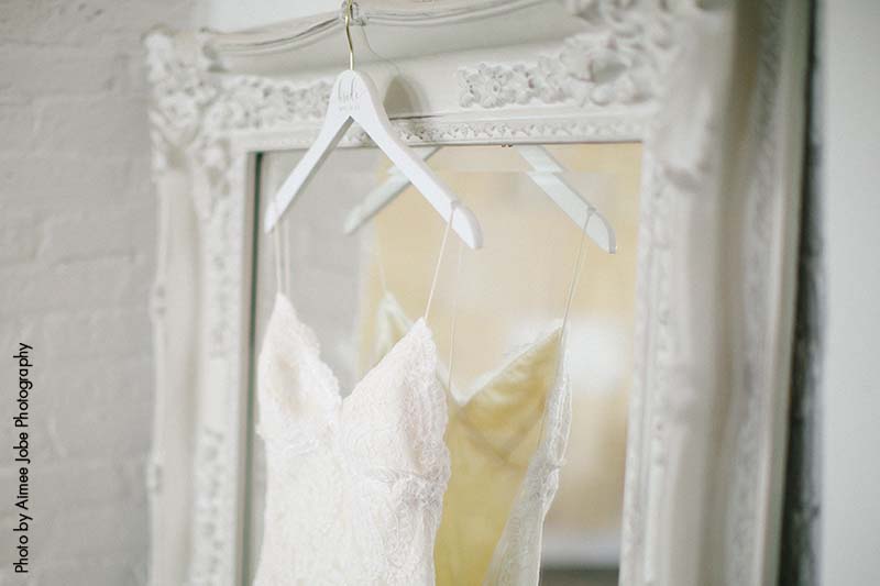 Custom wedding dress hanging with the brides name