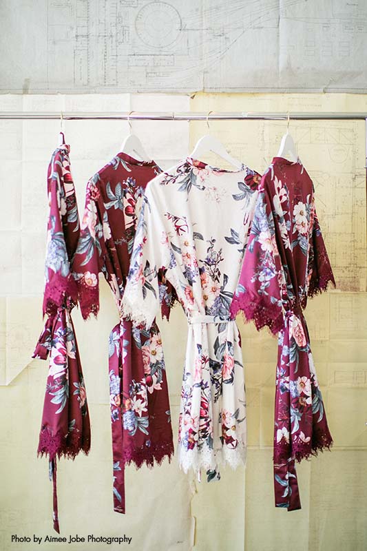 Matching maroon and white floral robes for the bride and bridal party