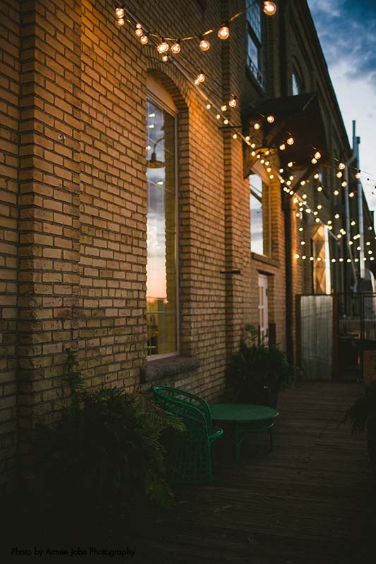 A modern rustic wedding venue in central Minnesota, with string lights and outdoor seating