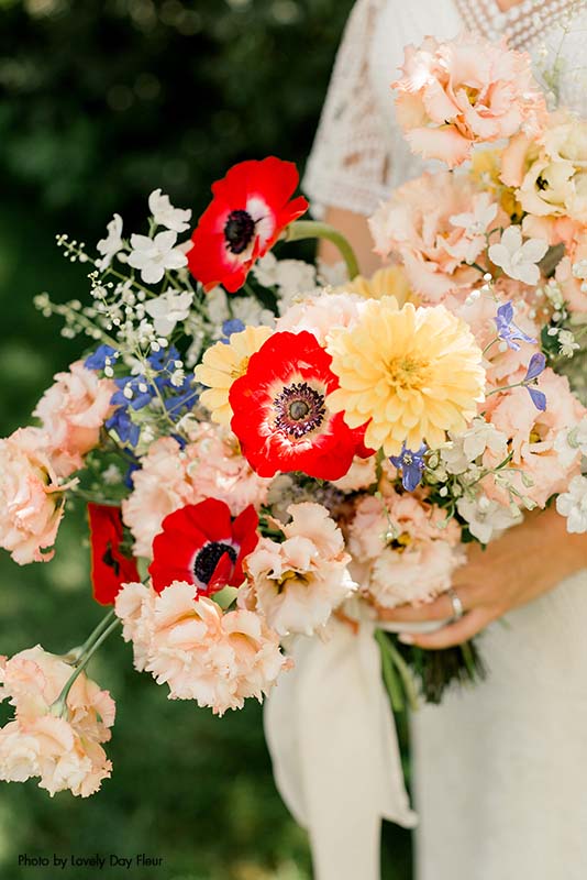 Assorted colorful flower bridal bouquet with red anemones