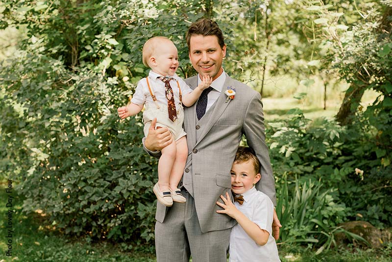 The groom and the ring bearers in neutral outfits