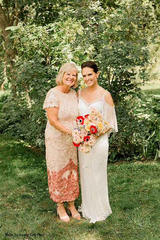 Mother of the bride in a sparkly dress with the bride in a boho gown