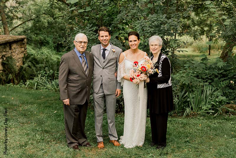 Photo of the bride and groom with their grandparents