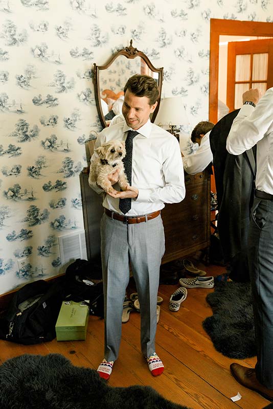 Groom poses with dog before wedding