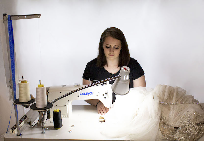 Seamstress alters bridal dress