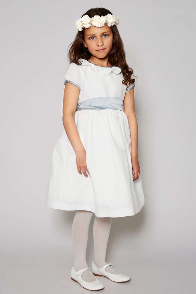 Flower girl in white dress with blue sash