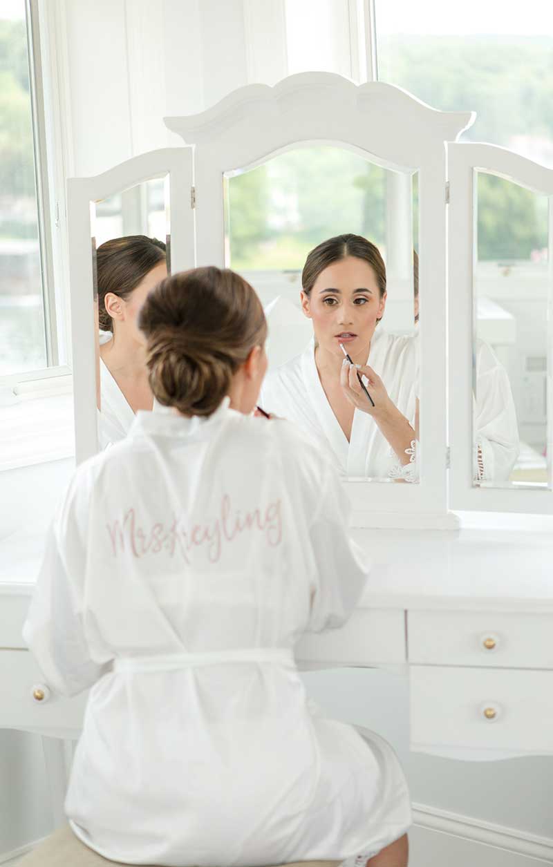 Bride in white robe getting ready