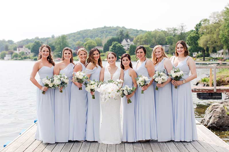 Bridesmaids in assorted light blue dresses