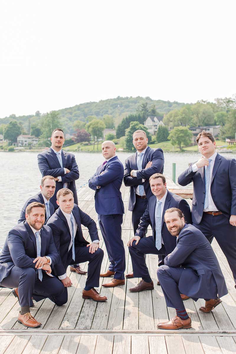 Groom and groomsmen in blue sets pose for photo
