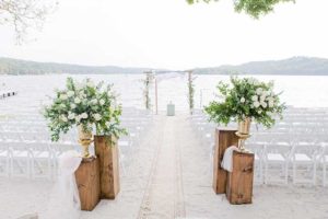White and green wedding ceremony by lake