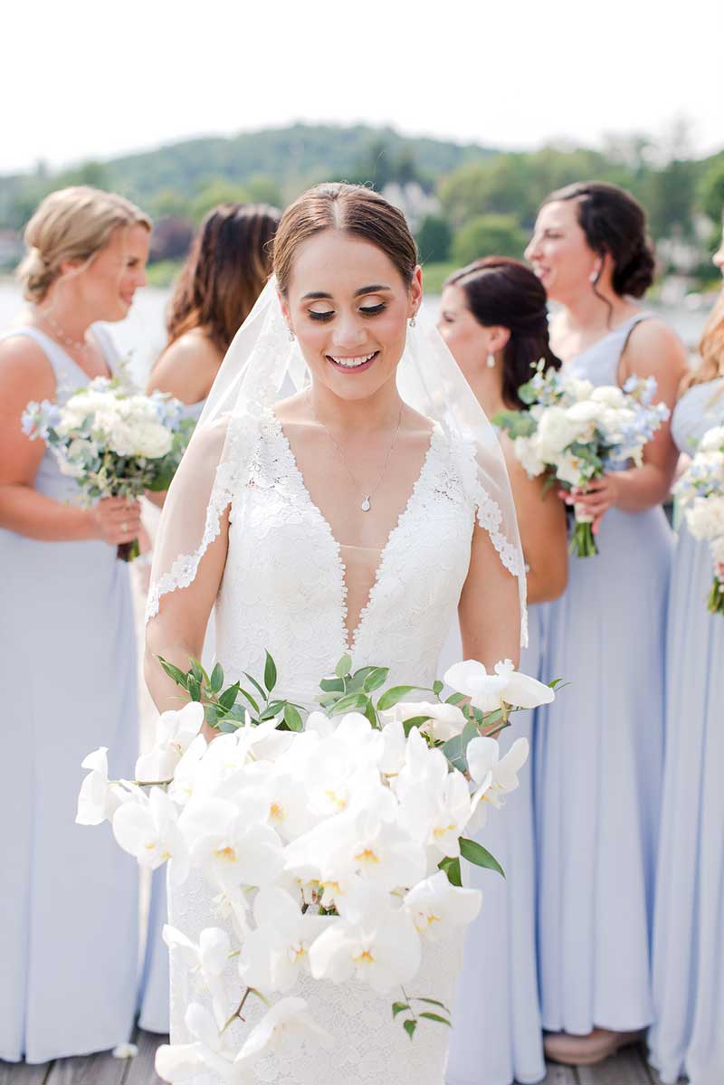 Bride in white dress with bridesmaids in blue dresses