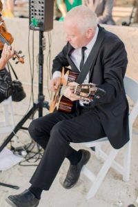 Man plays guitar during wedding ceremony