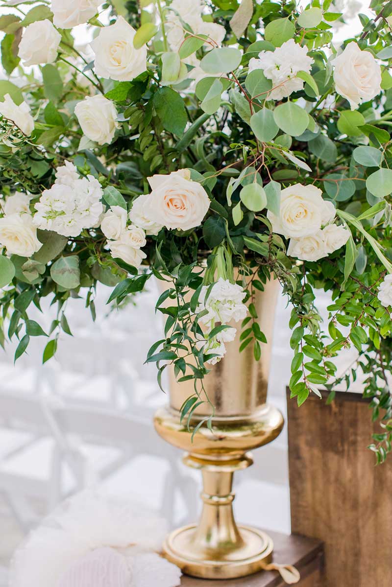 Summer wedding centerpiece with white roses and greenery