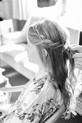 Hair stylist does a bridal half-up look for wedding