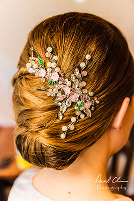 Classic wedding updo with floral beaded hairpiece