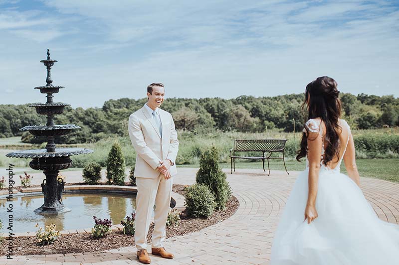 Groom in tan suit sees bride in couture wedding dress for first time