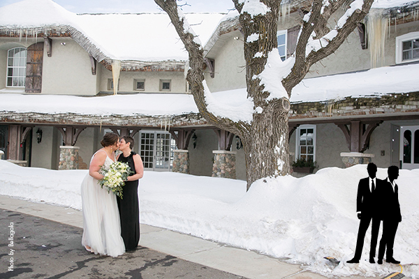 Brides kissing outside in winter Minnesota courtyard
