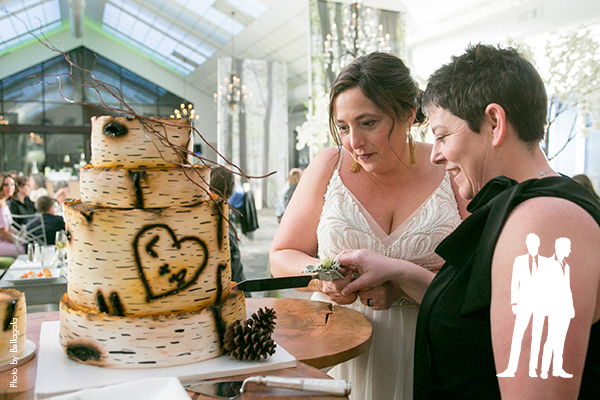 Brides cutting woodland themed wedding cake