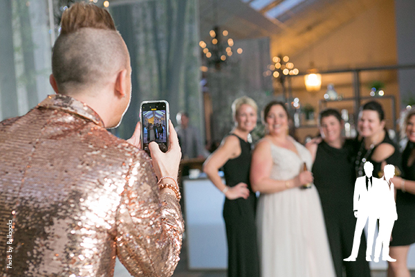 Guests taking pictures at forest themed wedding reception
