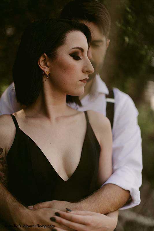 Couple poses at outdoor wedding