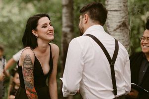 Bride and groom exchange vows at outdoor backyard weddin