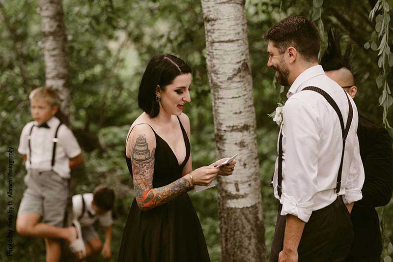 Bride reads vows at dark wedding ceremony