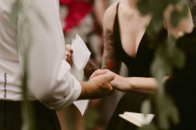 Bride and groom exchange vows outdoors