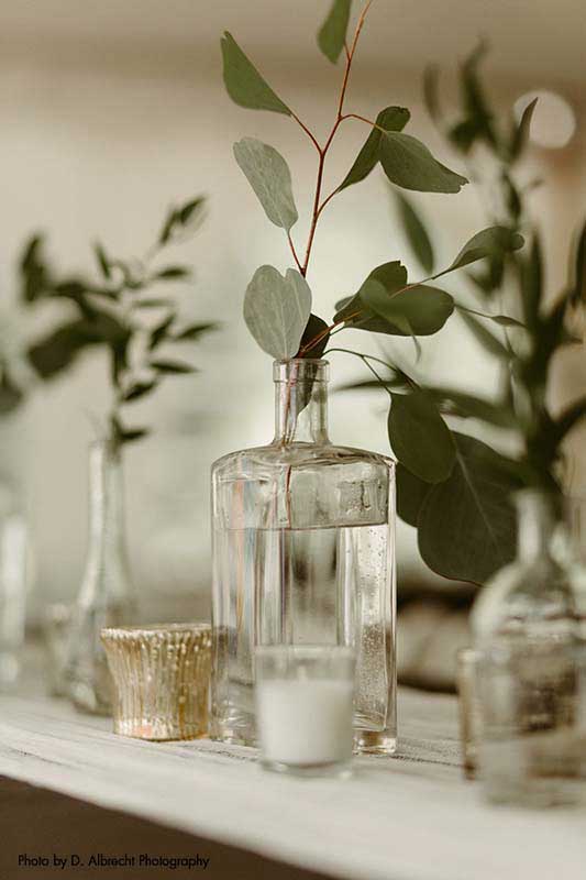 Eucalyptus in vase at dark wedding