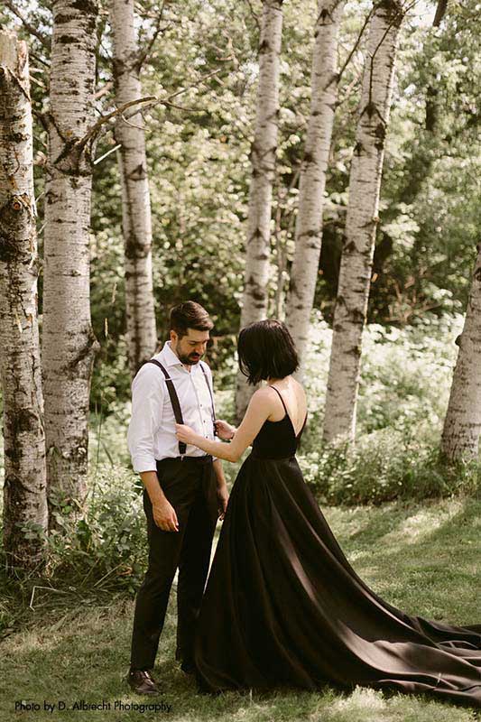 Bride and groom stand by birch trees in backyard dark wedding