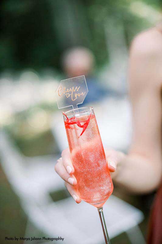 Custom wedding cocktail with "cheers to love" sign