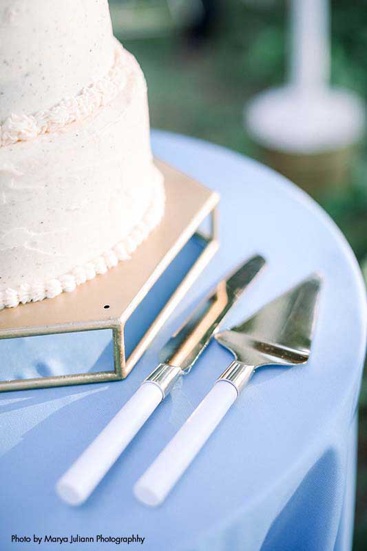 White and silver wedding cake serving utensils
