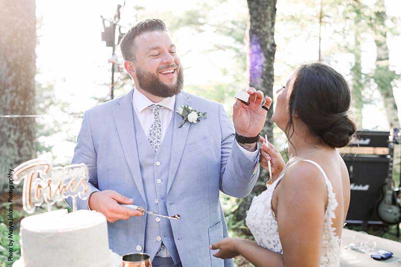 Groom feeds bride cake after intimate wedding ceremony