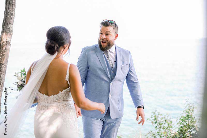 Groom in blue suit sees bride for first time