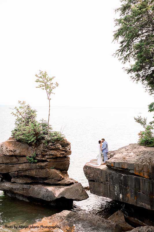 Couple poses for photo at Madeline Island rocks