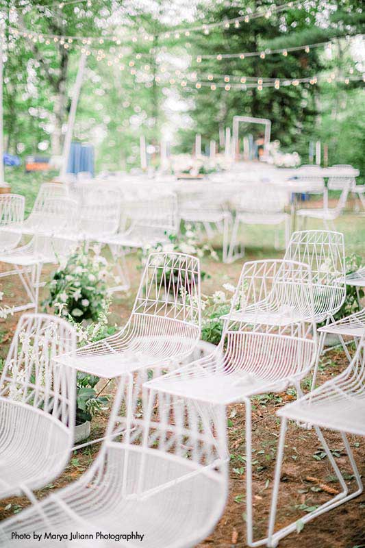 Modern white chairs for intimate wedding ceremony