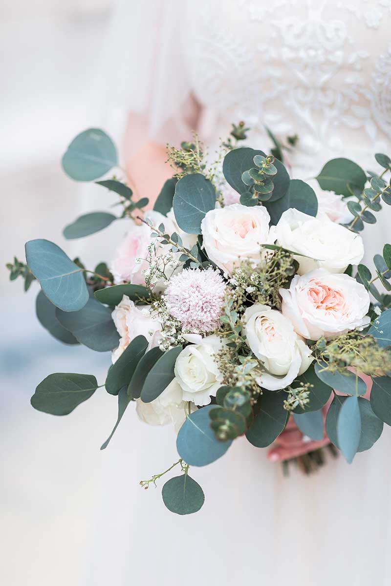 Winter wedding bouquet with white roses and eucalyptus