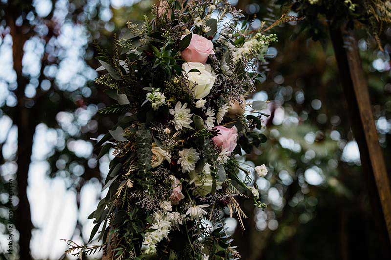 White blush and greenery wedding ceremony arch floral