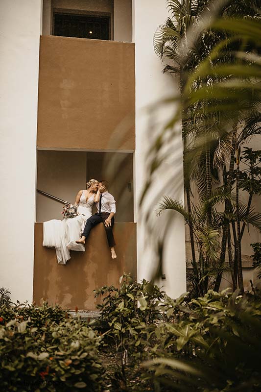 Bride and groom sit on balcony