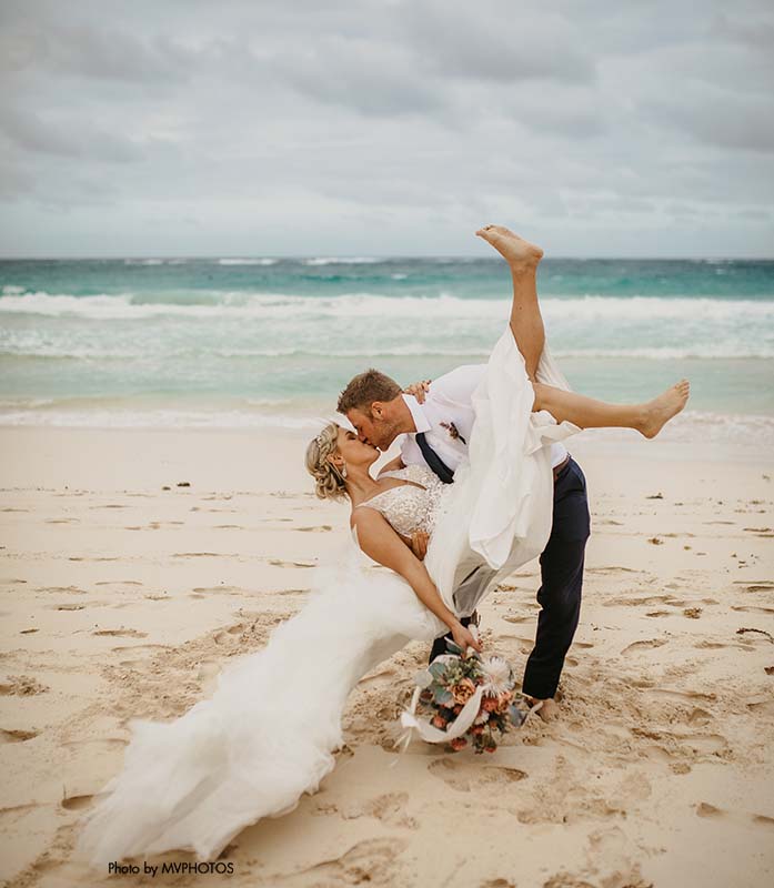Bride and groom kiss on the beach at Destination Wedding