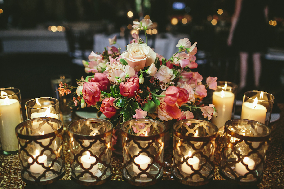 Gold geometric candle holders at wedding