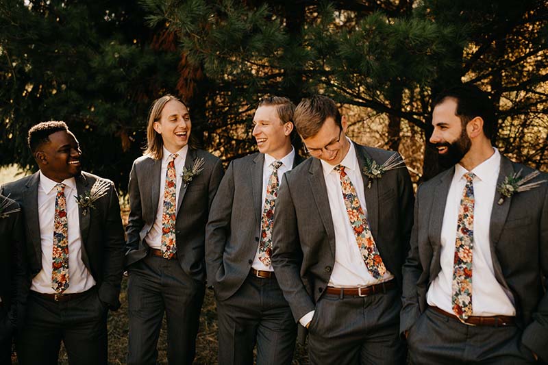 Groomsmen in gray suits and printed floral ties