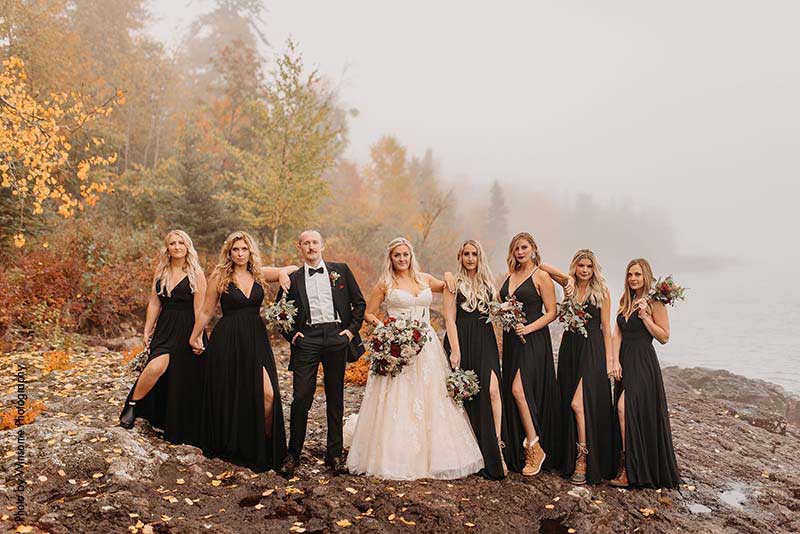 Wedding party poses for sassy photo with bride