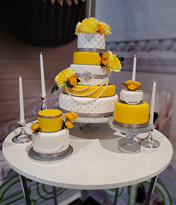 White and yellow wedding cake display