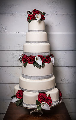Tall white wedding cake by Sweet Assurance
