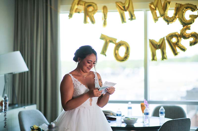 Bride reading note in bridal suite before ceremony