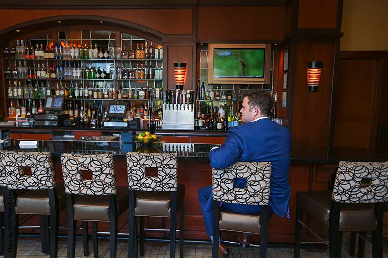 Groom sitting at the bar before the wedding ceremony