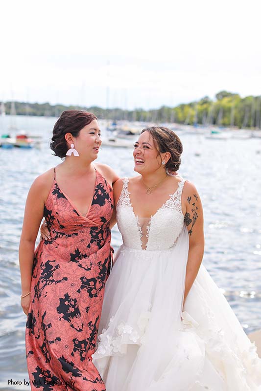 Bridesmaid wearing a pink and black floral dress